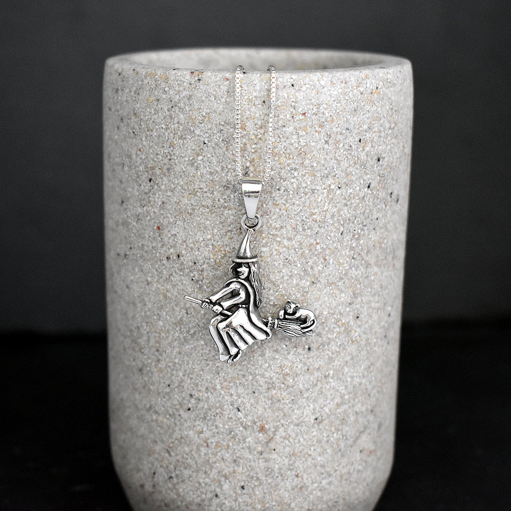 Liana witch on broomstick pendant