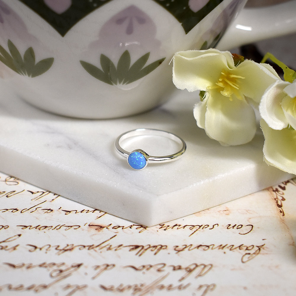 Angelica round blue opalique fine band ring