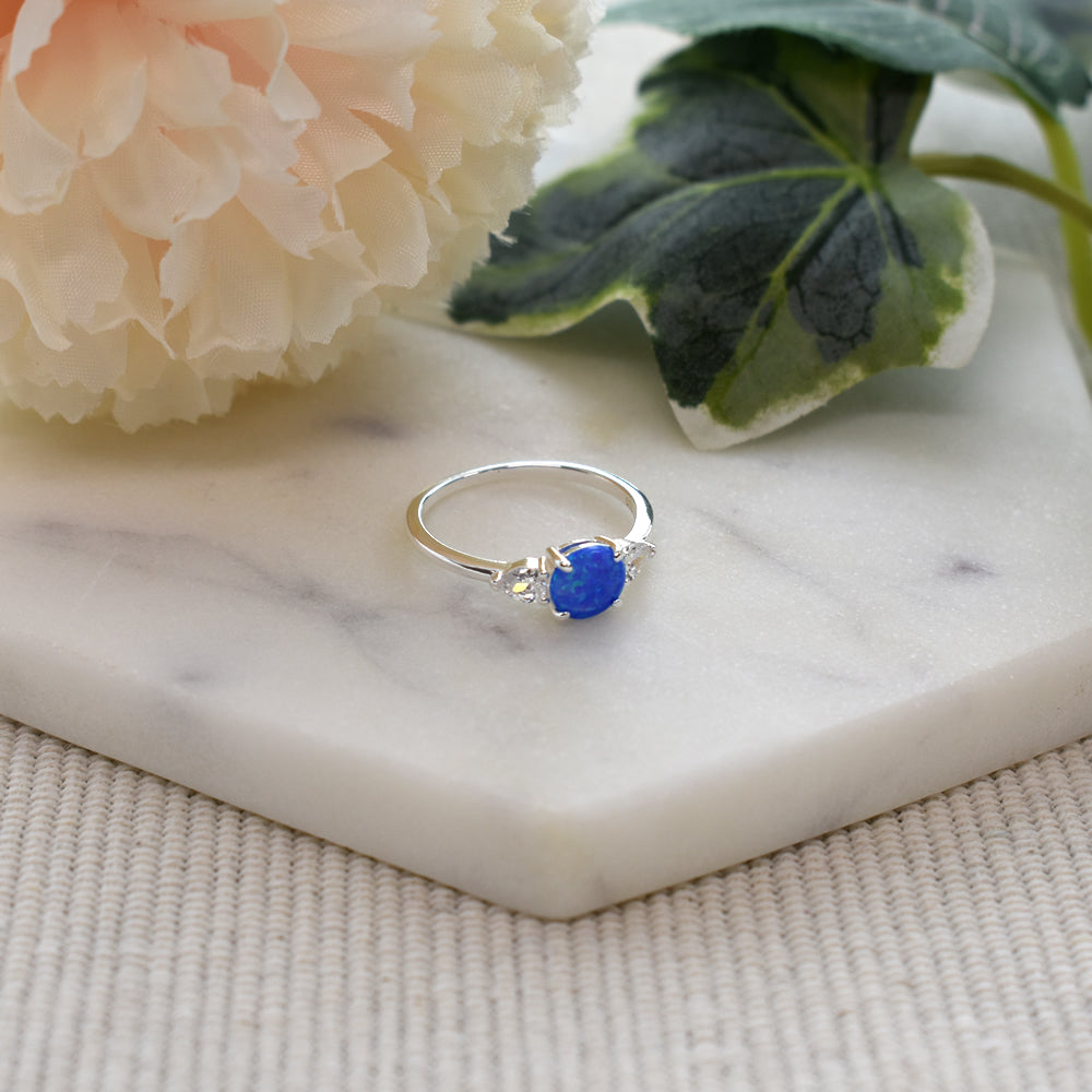 Bethan round blue opalique with teardrop CZ shoulder ring
