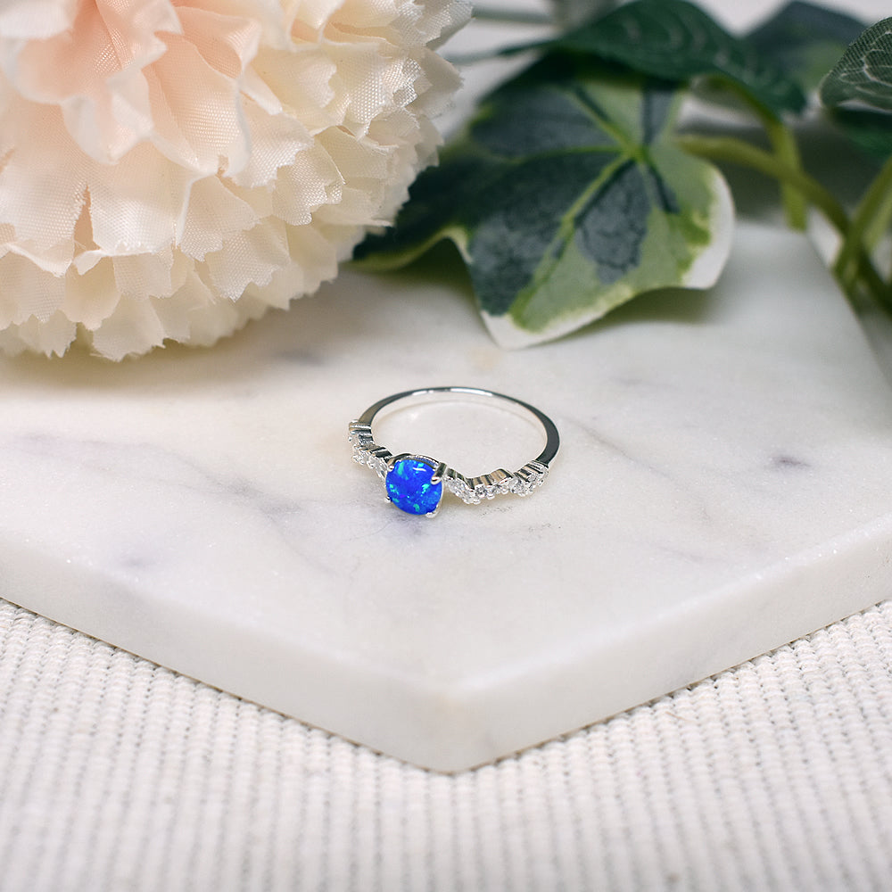 Bethan round blue opalique with wavy CZ shank ring