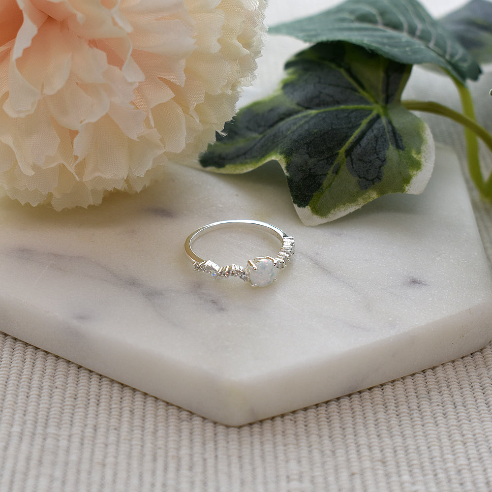 Bethan round white opalique with wavy CZ shank ring